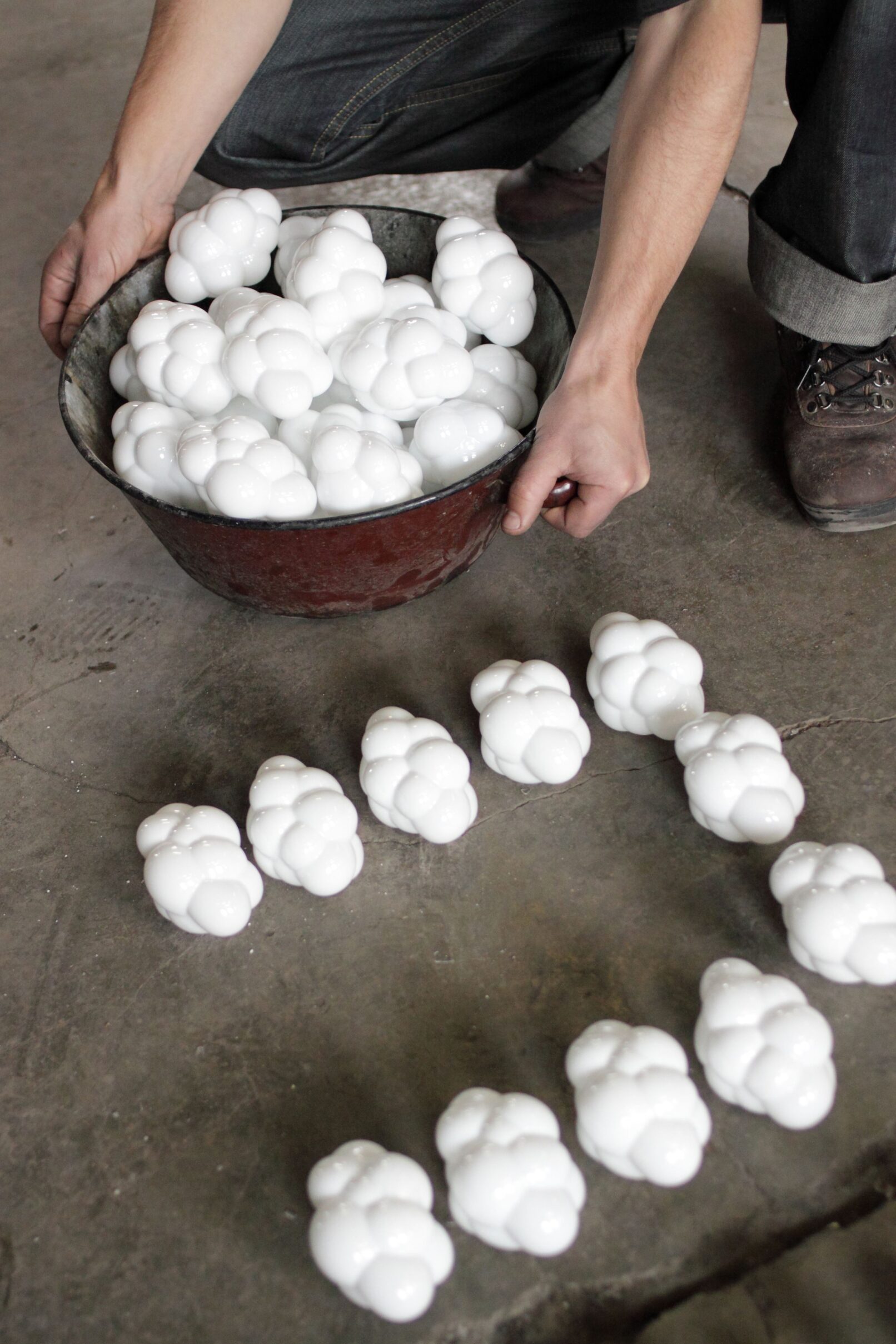 white cumulus clouds ornaments in a basket held by a glassmaker
